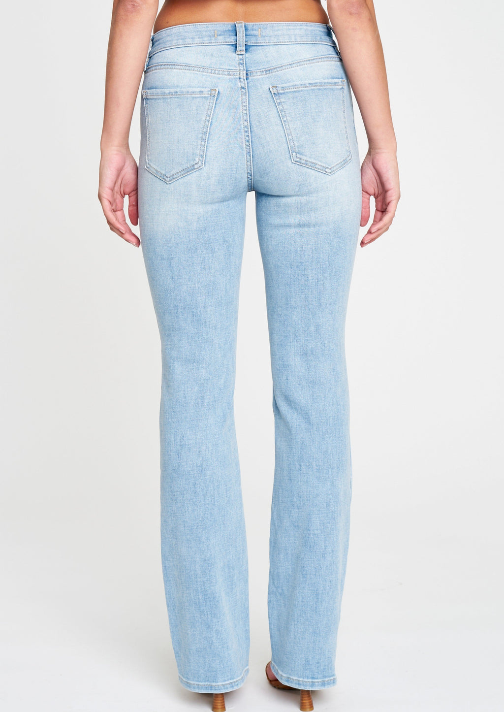 mid rise bootcut jeans in Fanatic. Clean, light wash with five pocket design, light fading, whiskering, and light distressing, and zip fly. This fit features a 9.5 in. mid rise and 32 in. regular inseam.