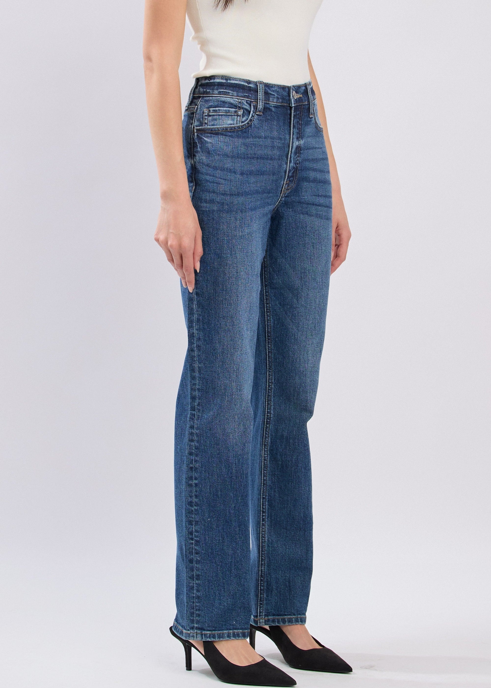 Person wearing blue jeans on a white background