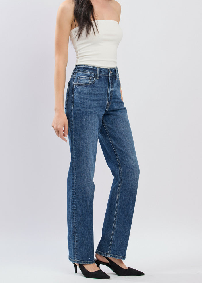 Woman wearing blue jeans and a white top on a white background