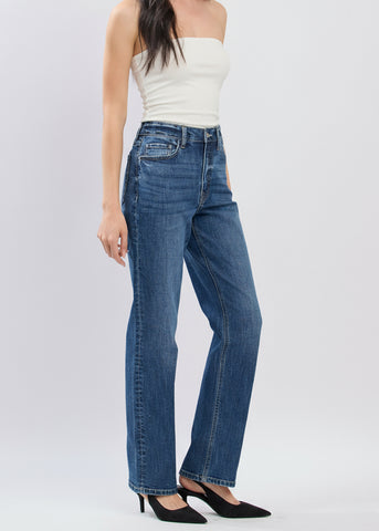 Woman wearing blue jeans and a white top on a white background