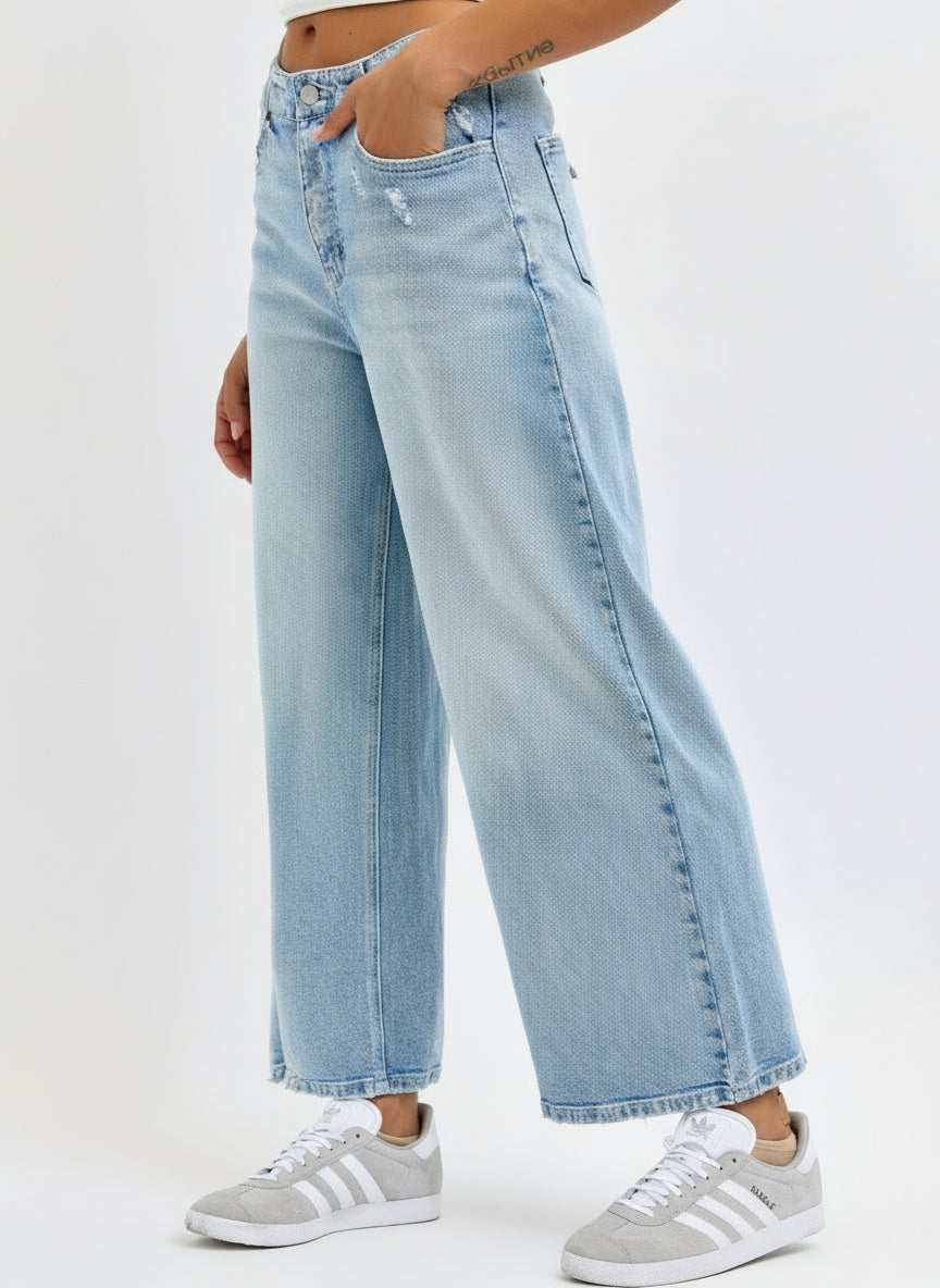 Light blue jeans worn by a person on a white background