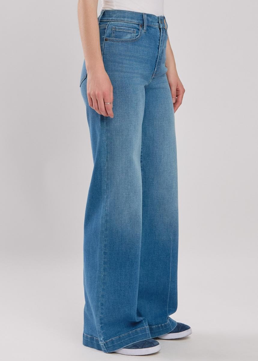 Person wearing blue jeans on a white background