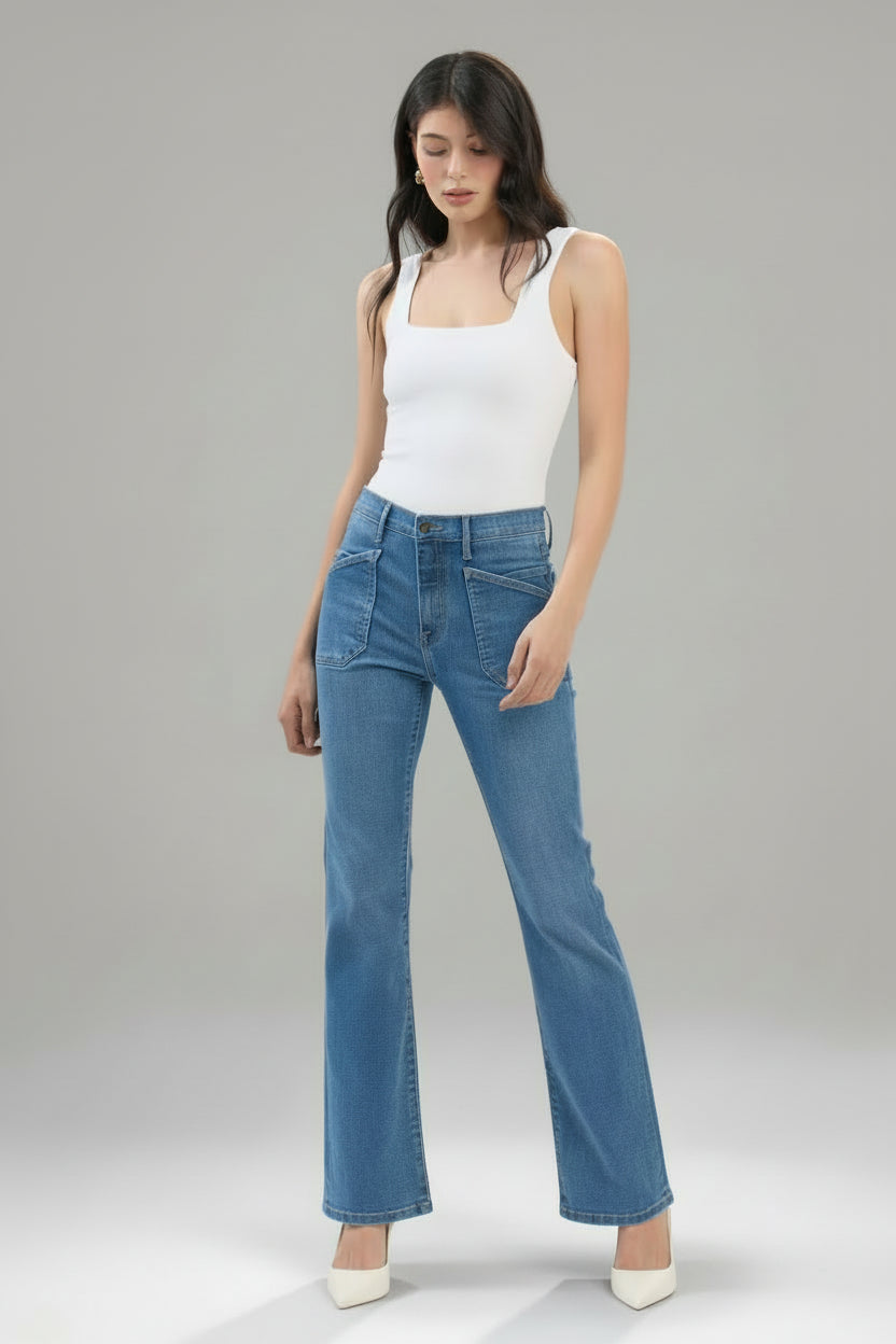 Woman wearing blue jeans and a white tank top on a white background