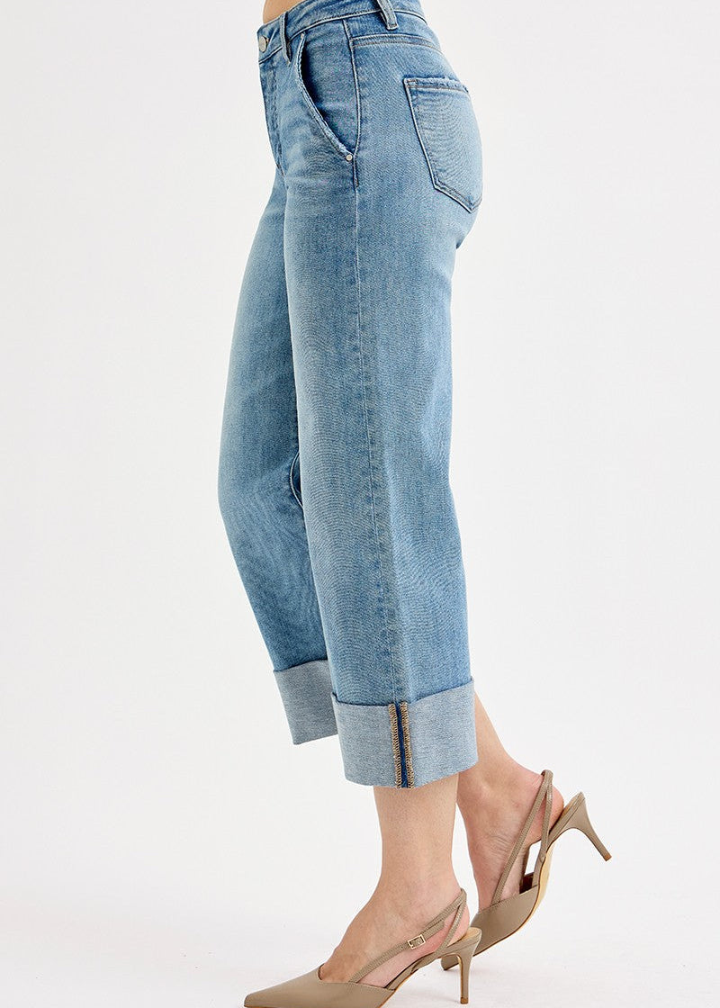 Light blue jeans worn by a person on a white background