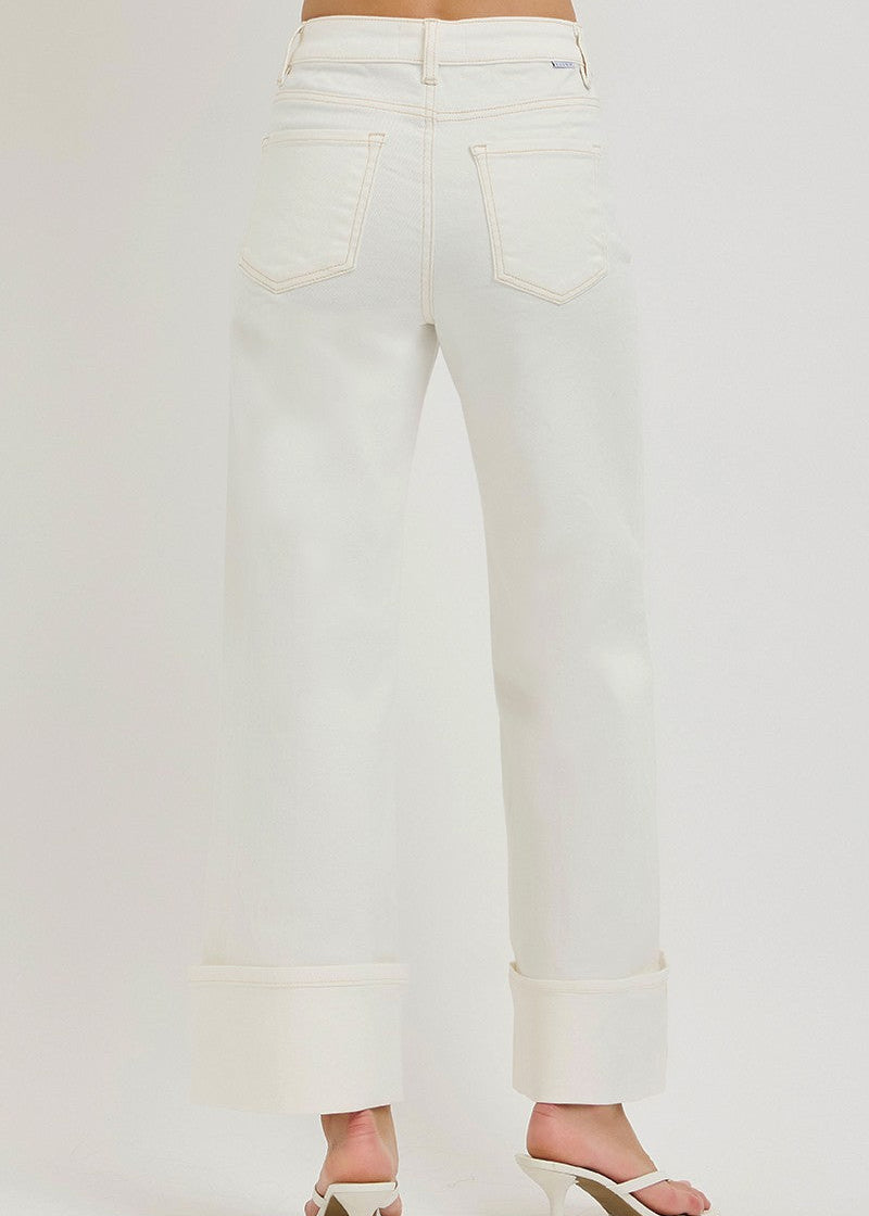 White jeans worn by a person on a white background