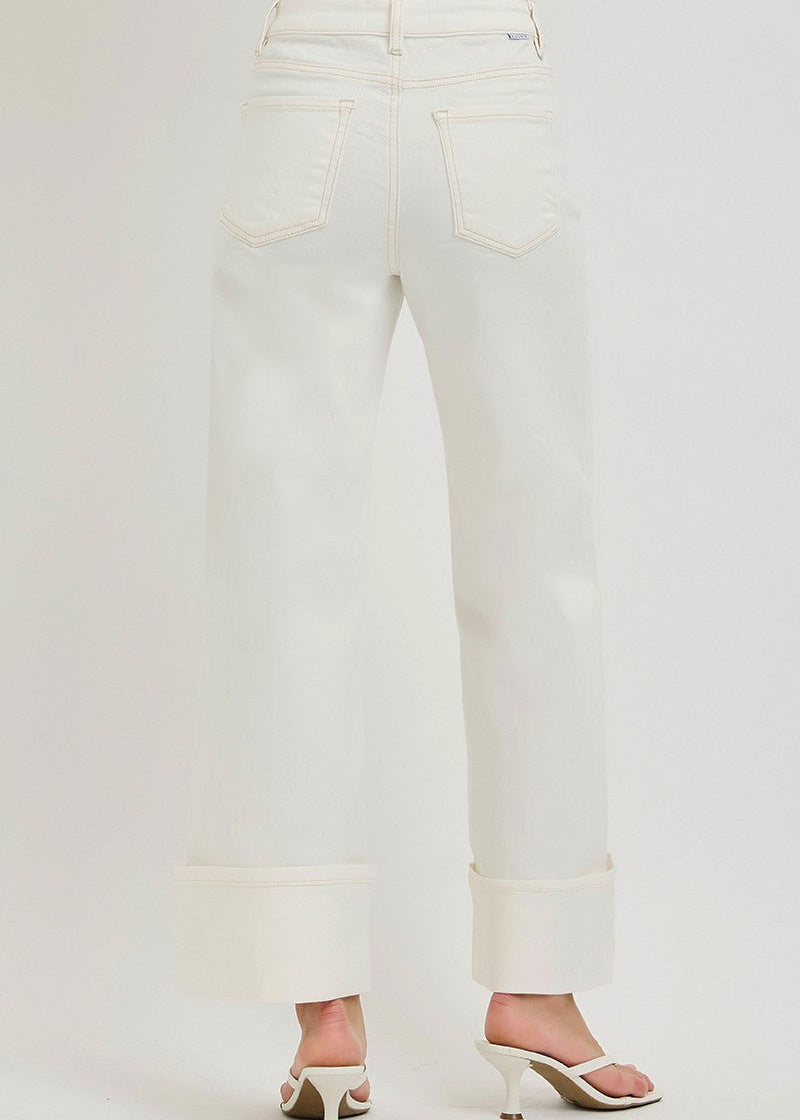 White jeans worn by a person on a white background