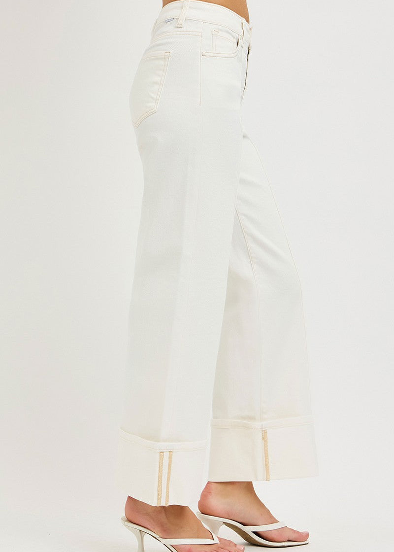 White jeans worn by a person on a white background
