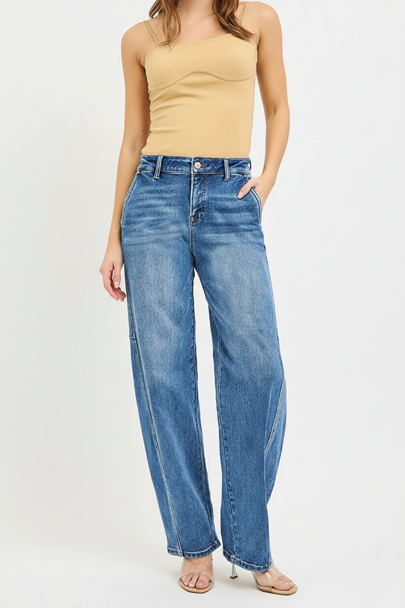 Woman wearing a beige strapless top and blue jeans on a white background